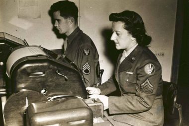 Sergeant Blanche Rubenstein and Staff Sergeant John J. Barrett handle incoming and outgoing messages at the Base Signal Center at Bradley Field.
