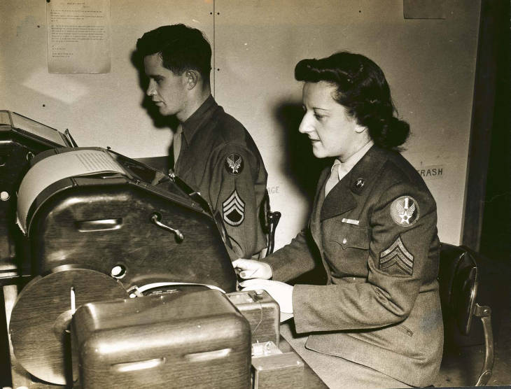 Sergeant Blanche Rubenstein and Staff Sergeant John J. Barrett handle incoming and outgoing messages at the Base Signal Center at Bradley Field.